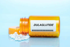 White Label Dulaglutide powder in amber pill bottle with white tablets spilled out