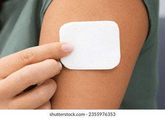 Person applying natural hormone replacement therapy patch on arm