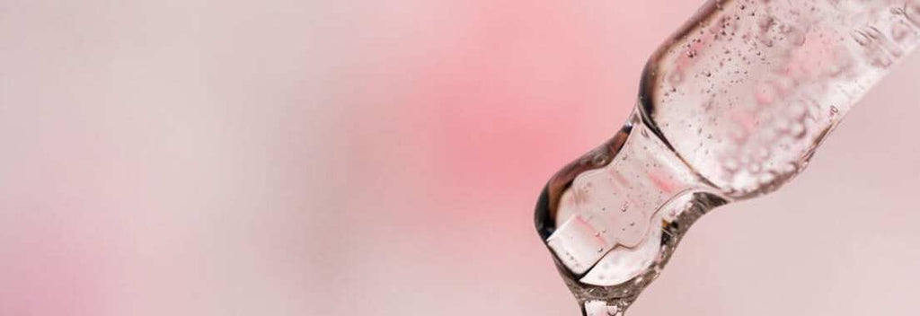 Close-up of a dropper dispensing clear 500ml Glutathione Topical Liquid Gel with Vitamin C for skin renewal and brightening